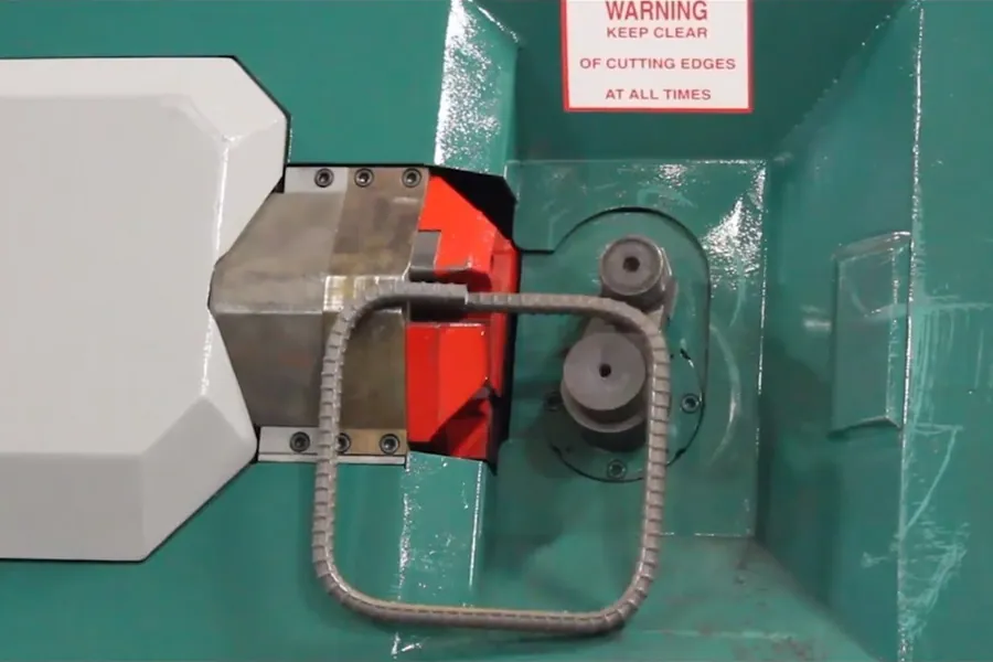 Close-up of a bending head forming a rebar stirrup.