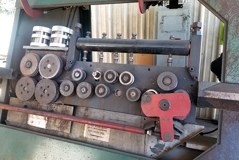 Close-up of the straightening and feed rolls on a stirrup bender.
